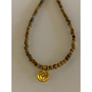 Brown bead necklace with tiny gold lotus flower pendant